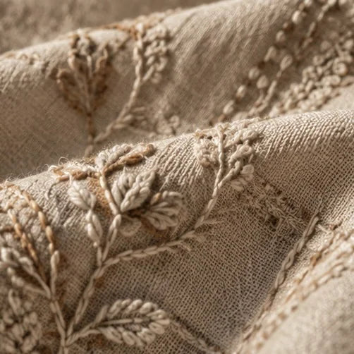 Delicate hand embroidery on a natural textile